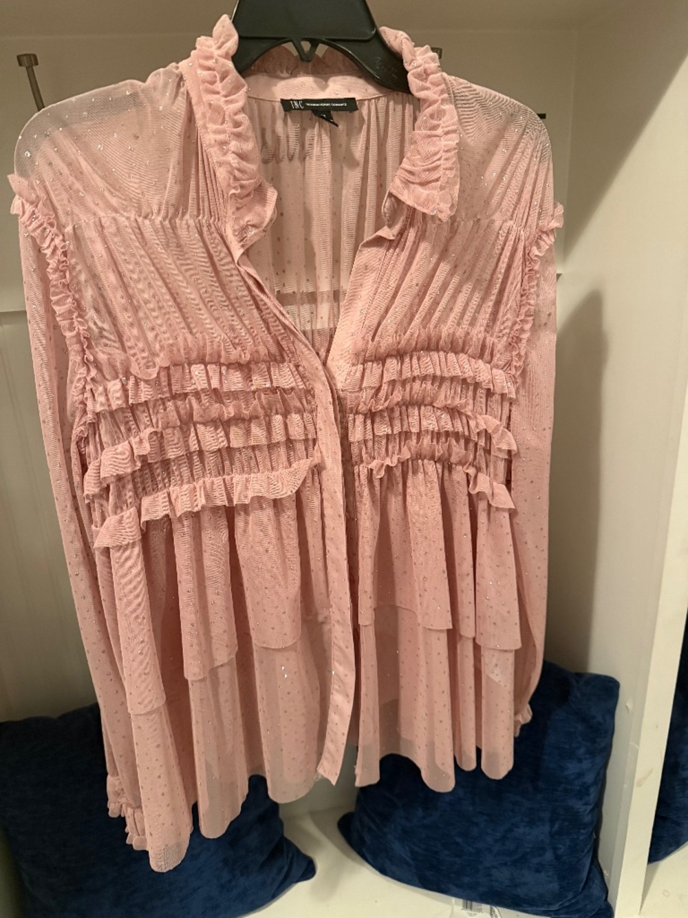 This is a soft blush pink, feminine ruffle blouse with an elegant and romantic s